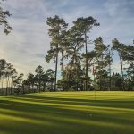 Panoramic view of a lush green golf course at Ames Golf & Country Club. Smooth