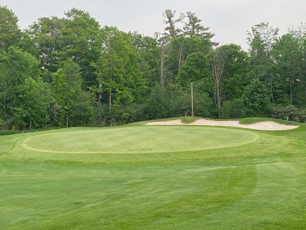 Panoramic view of a lush green golf course at Apache Wells Country Club. Smooth