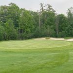 Panoramic view of a lush green golf course at Apache Wells Country Club. Smooth