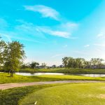 Panoramic view of a lush green golf course at Balboa Golf Course. Smooth