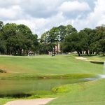 Panoramic view of a lush green golf course at Bellair Golf Park. Smooth