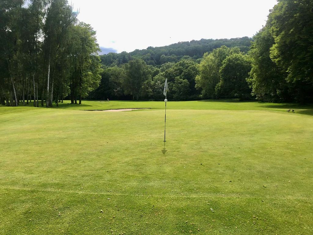 Panoramic view of a lush green golf course at Bent Creek Golf Course. Smooth