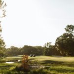 Panoramic view of a lush green golf course at Berksdale Golf Course. Smooth
