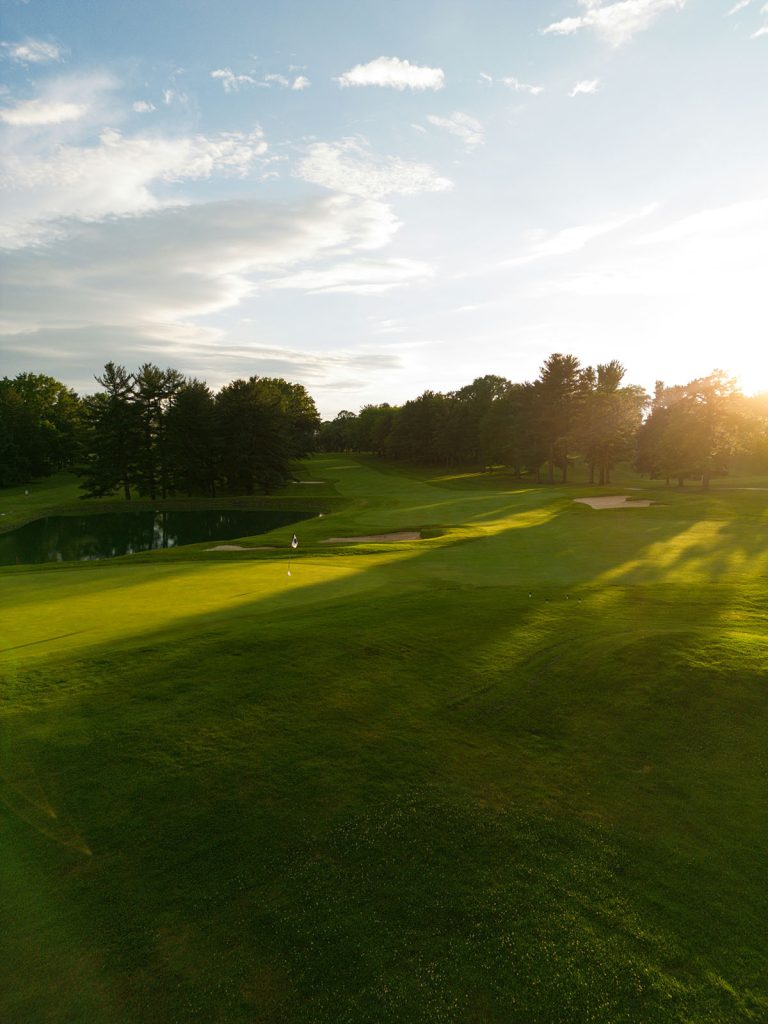 Panoramic view of a lush green golf course at Centennial Valley Golf. Smooth