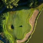 Panoramic view of a lush green golf course at Chi Chi Rodriguez Golf Club. Smooth