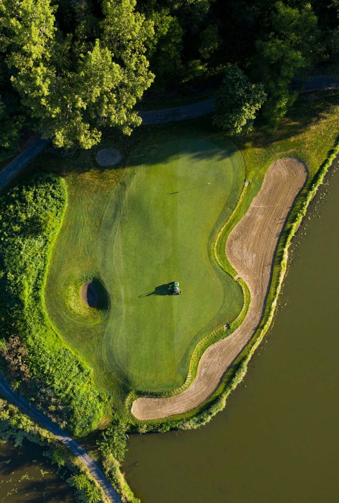 Panoramic view of a lush green golf course at Chi Chi Rodriguez Golf Club. Smooth
