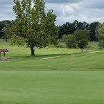 Panoramic view of a lush green golf course at Cooper's Hawk Golf Course. Smooth