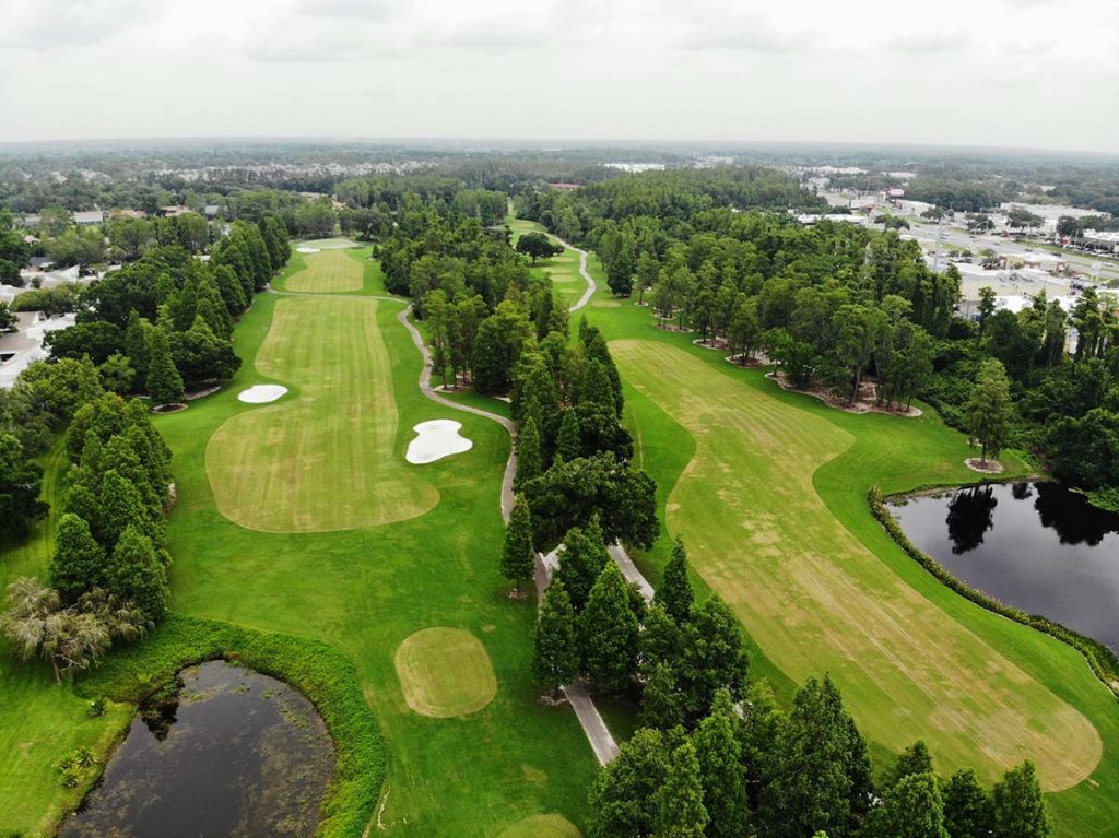 Panoramic view of a lush green golf course at Crazy Horse Sports Club And Golf Course. Smooth