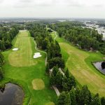 Panoramic view of a lush green golf course at Crazy Horse Sports Club And Golf Course. Smooth
