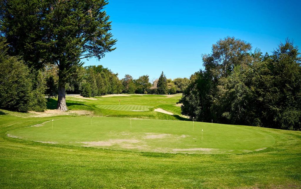 Panoramic view of a lush green golf course at Ellis Golf Club. Smooth