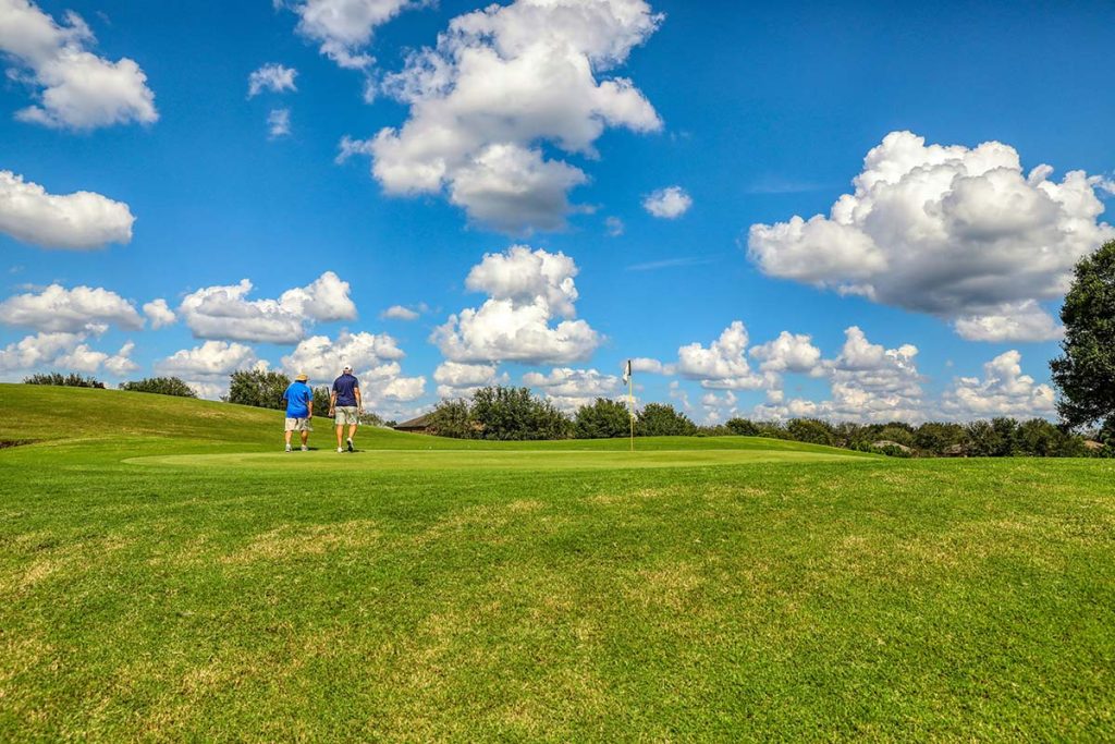 Panoramic view of a lush green golf course at Fall Creek Golf Club. Smooth