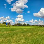 Panoramic view of a lush green golf course at Fall Creek Golf Club. Smooth