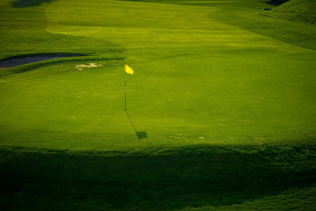 Panoramic view of a lush green golf course at Indian Creek Golf Club. Smooth