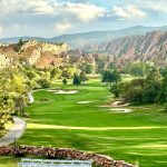 Panoramic view of a lush green golf course at Isla Del Sol Yacht & Country Club. Smooth