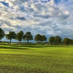 Panoramic view of a lush green golf course at Klein Creek Golf Club. Smooth