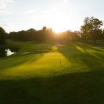 Panoramic view of a lush green golf course at La Paloma Country Club. Smooth