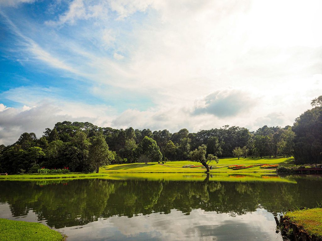 Panoramic view of a lush green golf course at Lake Quivira Country Club. Smooth