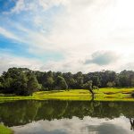 Panoramic view of a lush green golf course at Lake Quivira Country Club. Smooth