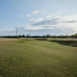 Panoramic view of a lush green golf course at Metairie Country Club. Smooth