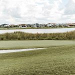 Panoramic view of a lush green golf course at Mulligan's Pointe. Smooth