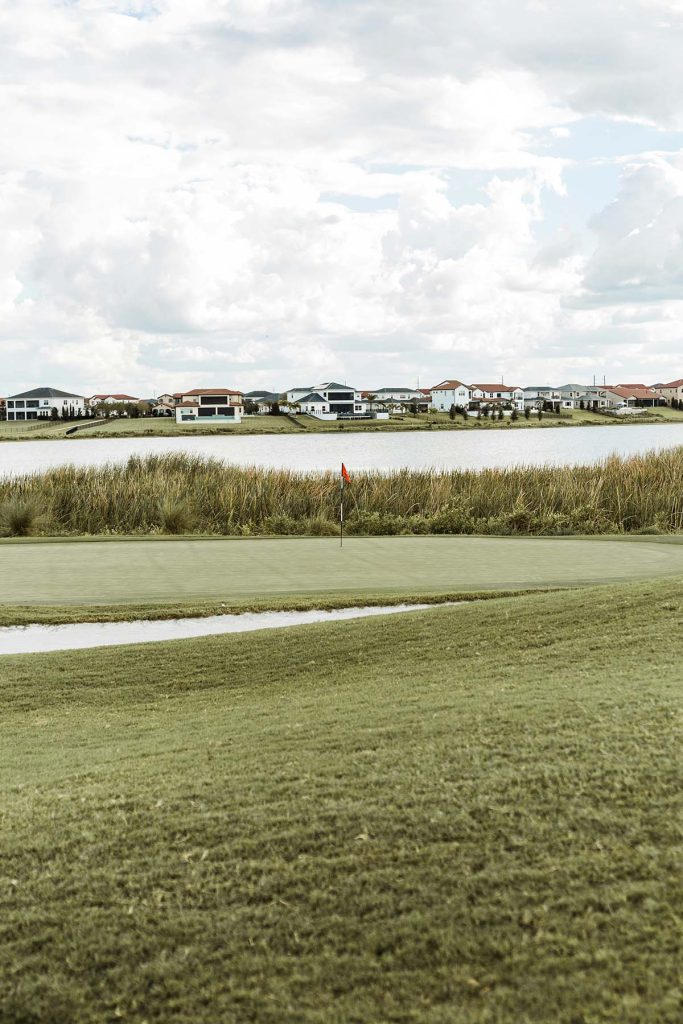 Panoramic view of a lush green golf course at Mulligan's Pointe. Smooth
