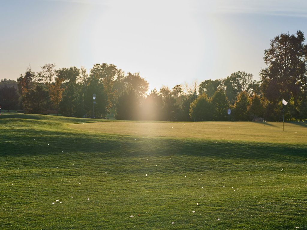 Panoramic view of a lush green golf course at New Orleans Country Club. Smooth