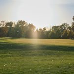 Panoramic view of a lush green golf course at New Orleans Country Club. Smooth