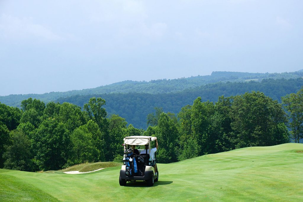 Panoramic view of a lush green golf course at Oakley Country Club. Smooth