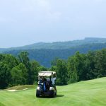 Panoramic view of a lush green golf course at Oakley Country Club. Smooth