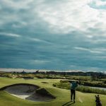 Panoramic view of a lush green golf course at Osprey Cove. Smooth