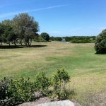 Panoramic view of a lush green golf course at Shadow Valley Country Club. Smooth