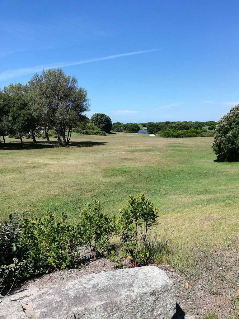 Panoramic view of a lush green golf course at Shadow Valley Country Club. Smooth