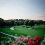 Panoramic view of a lush green golf course at Siloam Springs Golf Club. Smooth