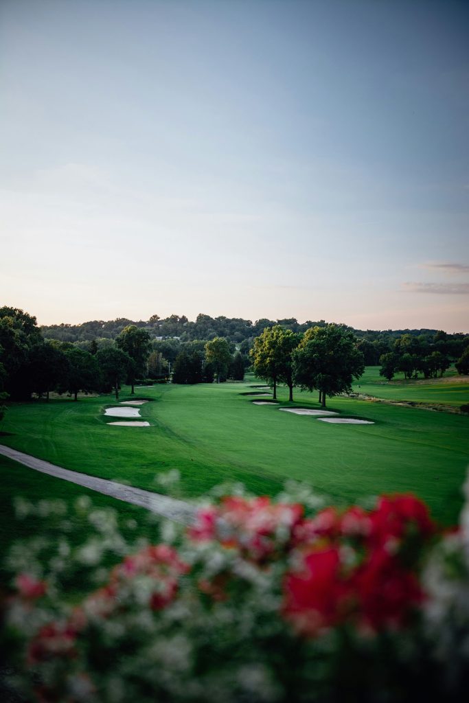 Panoramic view of a lush green golf course at Siloam Springs Golf Club. Smooth