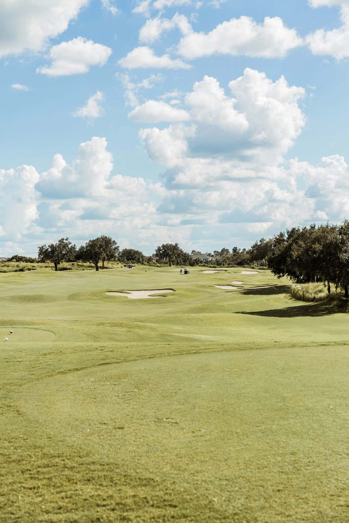 Panoramic view of a lush green golf course at Silver Springs Country Club. Smooth