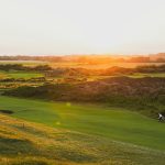 Panoramic view of a lush green golf course at Sugar Bay Golf Course. Smooth