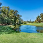 Panoramic view of a lush green golf course at TPC Sawgrass. Smooth
