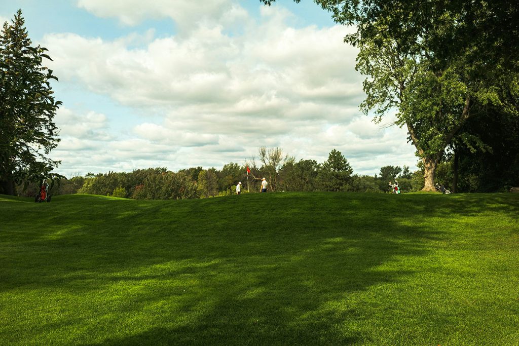Panoramic view of a lush green golf course at The Coeur d'Alene Resort. Smooth
