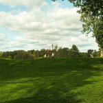 Panoramic view of a lush green golf course at The Coeur d'Alene Resort. Smooth