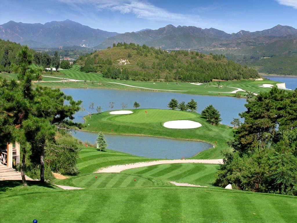 Panoramic view of a lush green golf course at The Executive 9 at Woodland Hills. Smooth