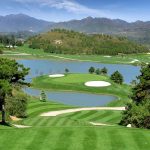 Panoramic view of a lush green golf course at The Executive 9 at Woodland Hills. Smooth