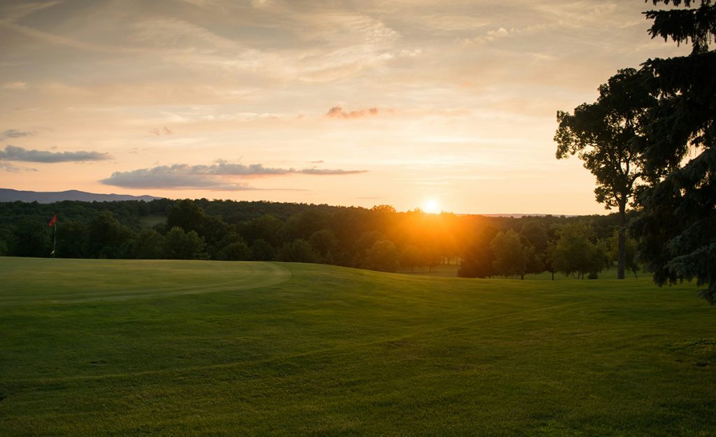 Panoramic view of a lush green golf course at The Island Golf Course. Smooth