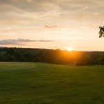 Panoramic view of a lush green golf course at The Island Golf Course. Smooth