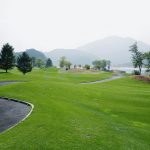 Panoramic view of a lush green golf course at The Ledges. Smooth