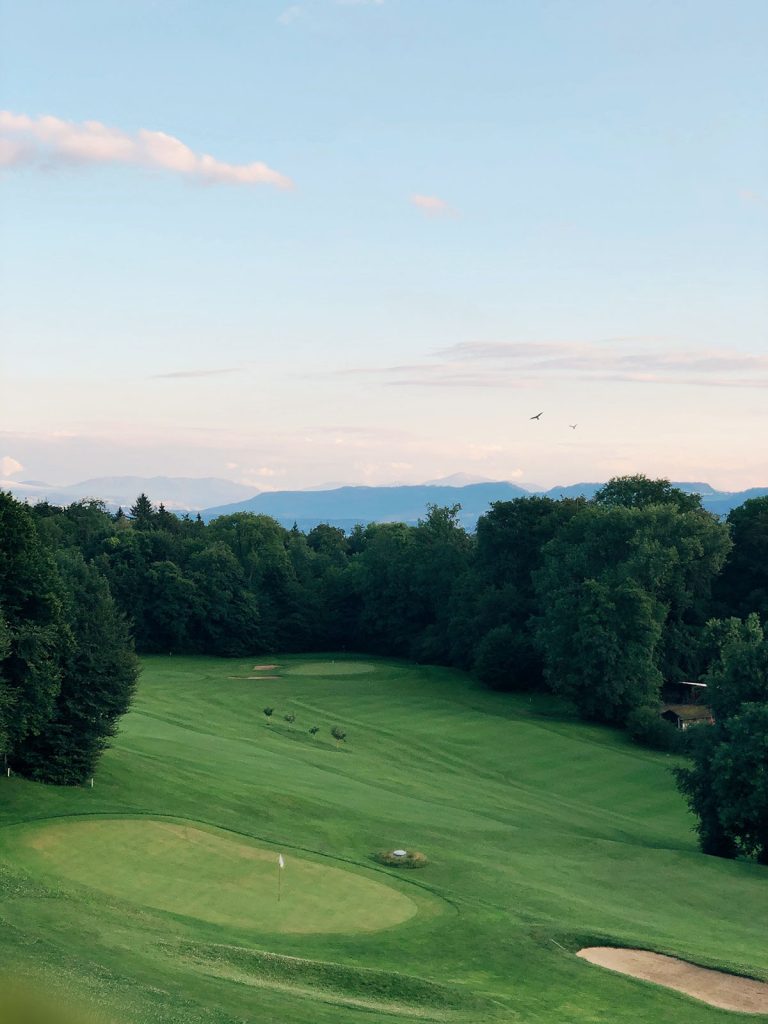Panoramic view of a lush green golf course at The Players Club at Woodland Trails. Smooth