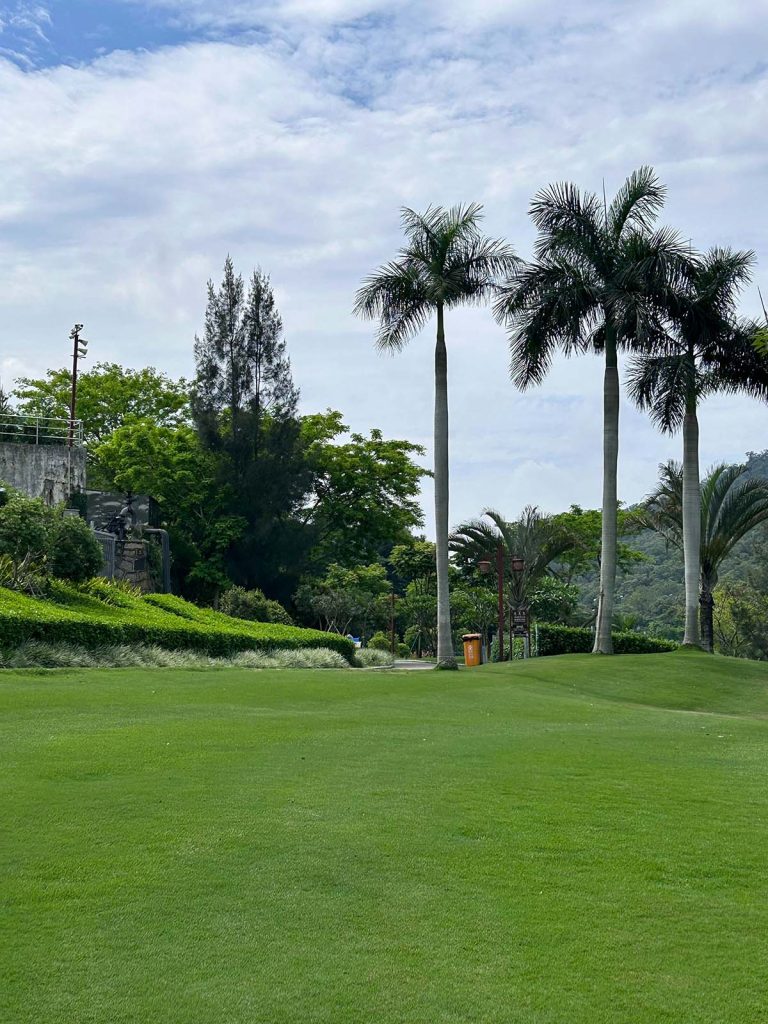 Panoramic view of a lush green golf course at The River Club. Smooth