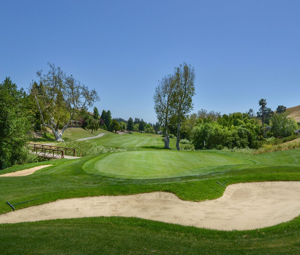 Panoramic view of a lush green golf course at Timber Ridge Golf Course. Smooth