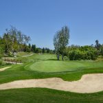 Panoramic view of a lush green golf course at Timber Ridge Golf Course. Smooth