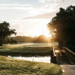 Panoramic view of a lush green golf course at TopCITYGolf at GreatLIFE North. Smooth