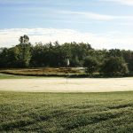 Panoramic view of a lush green golf course at Trailside Golf & Footgolf. Smooth